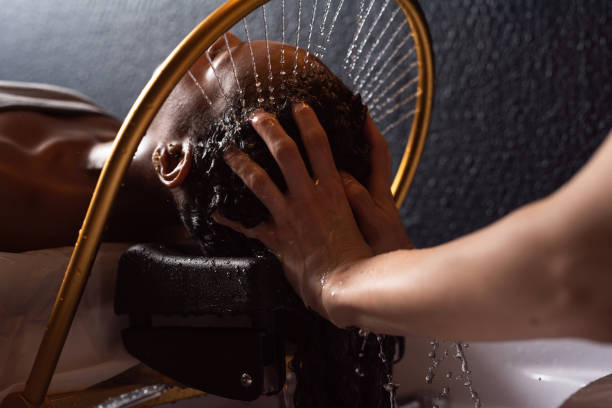 Close up of relaxing hair wash at a salon.